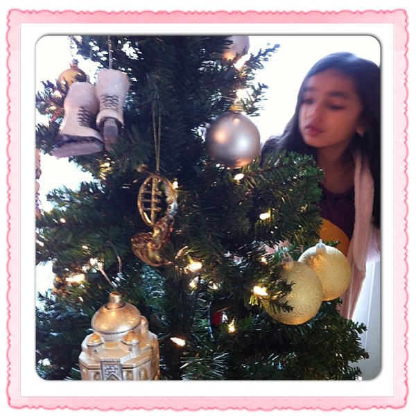 Maya trimming our Kmart tree...